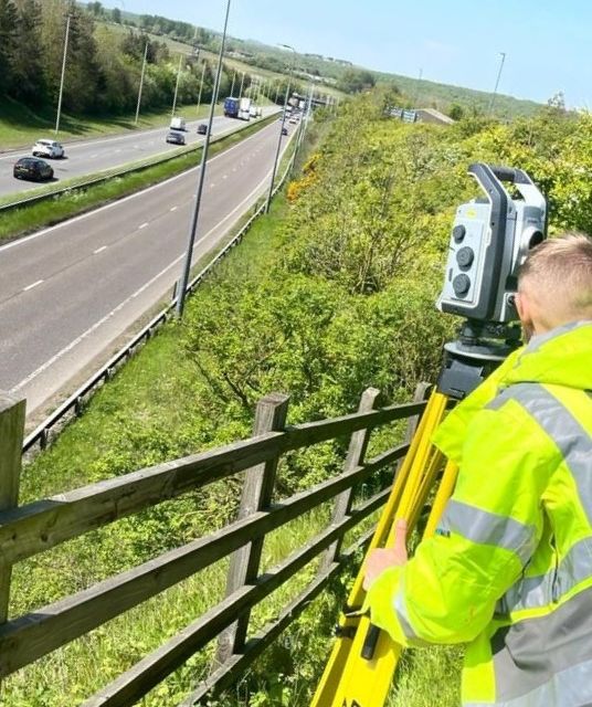 Topographical Surveyor, surveying busy road